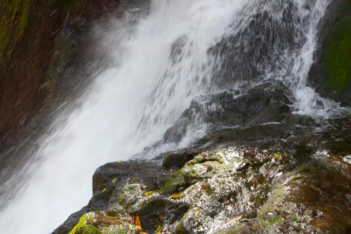 a large waterfall over some water