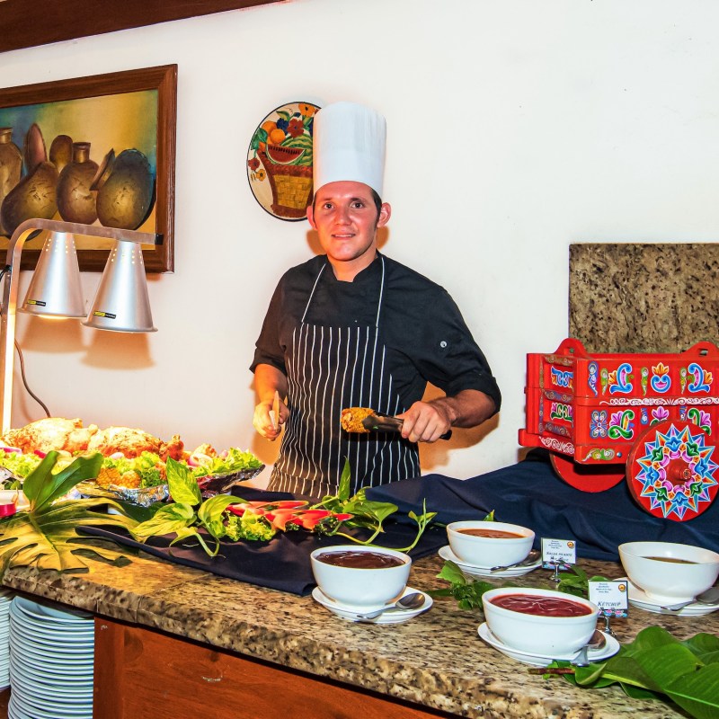 Chef serving food at Hotel Hacienda Guachpelin