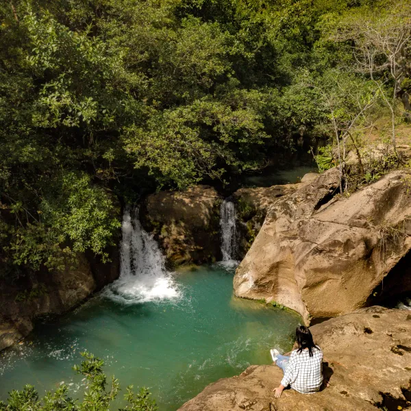 a large waterfall over a body of water