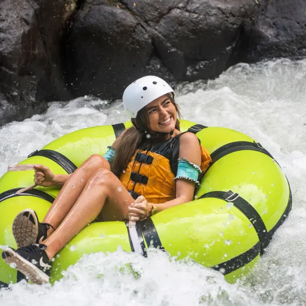 Leila Barros riding a snow board on a raft