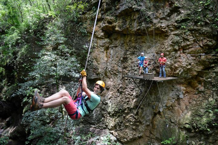 a person flying through the air on a rock