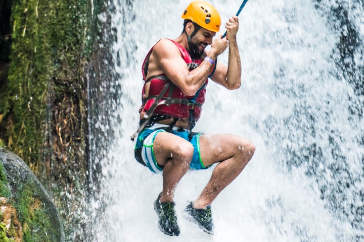 a man riding a wave on a surfboard in the water