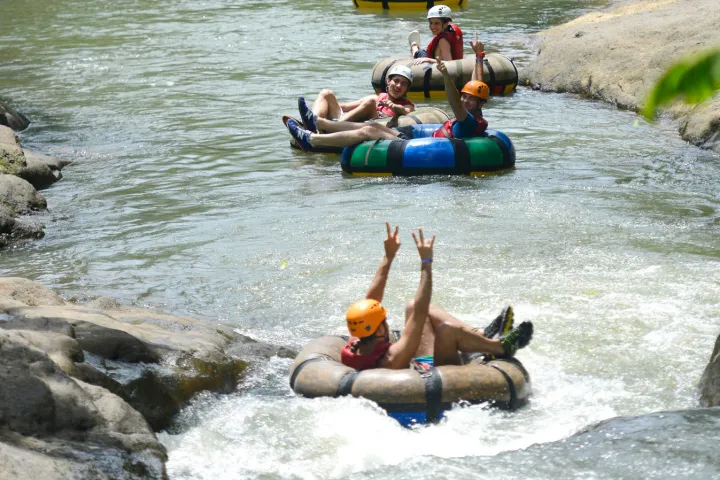 a group of people on a raft in a body of water