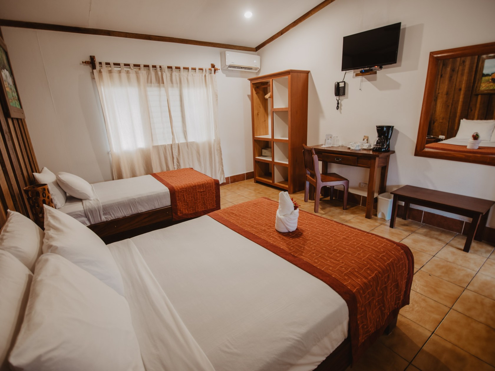 a bedroom with a bed and desk in a room