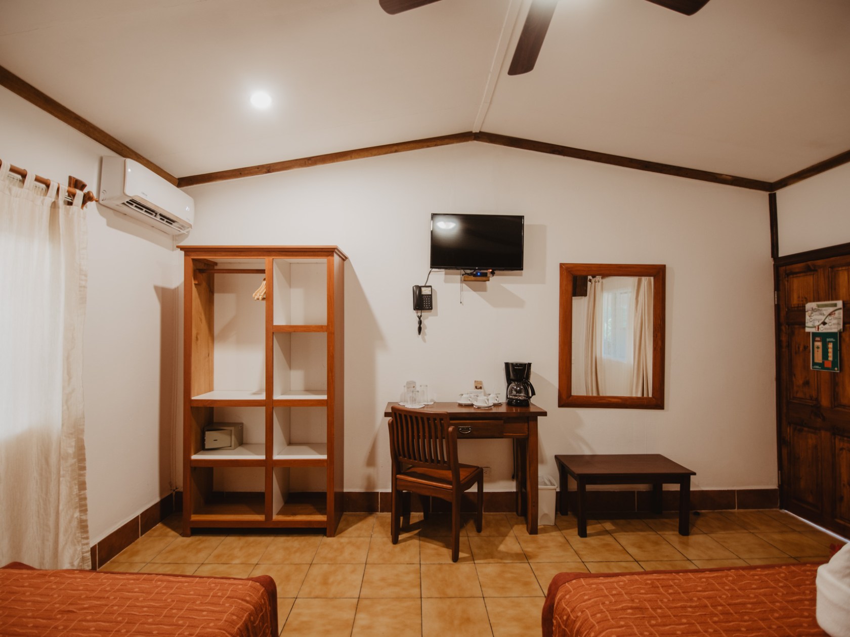 a bedroom with a bed and a chair in a room