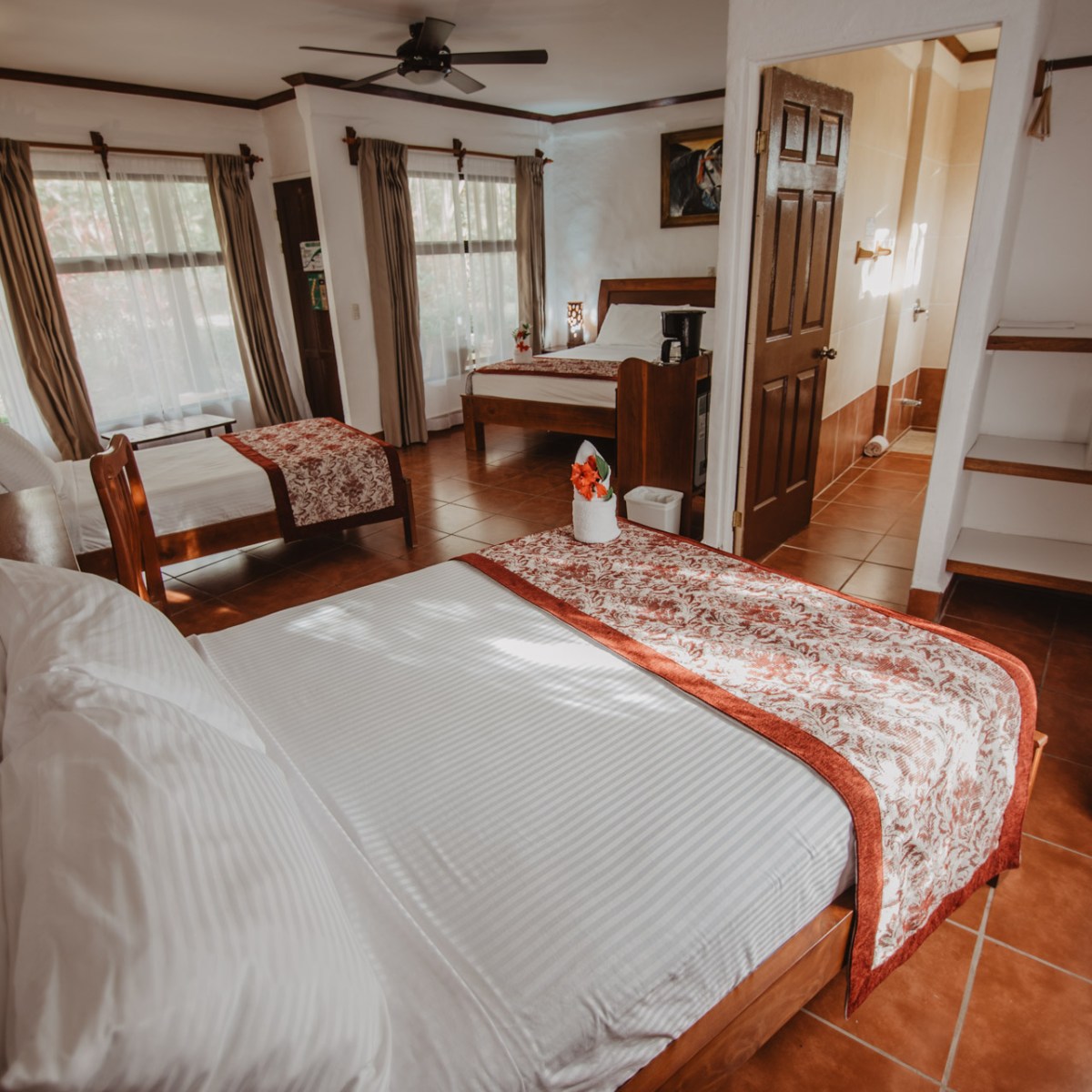 a bedroom with a bed and chair in a room
