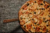 a pizza sitting on top of a metal pan