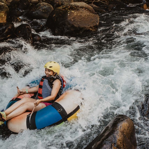 a person lying on a raft in a body of water