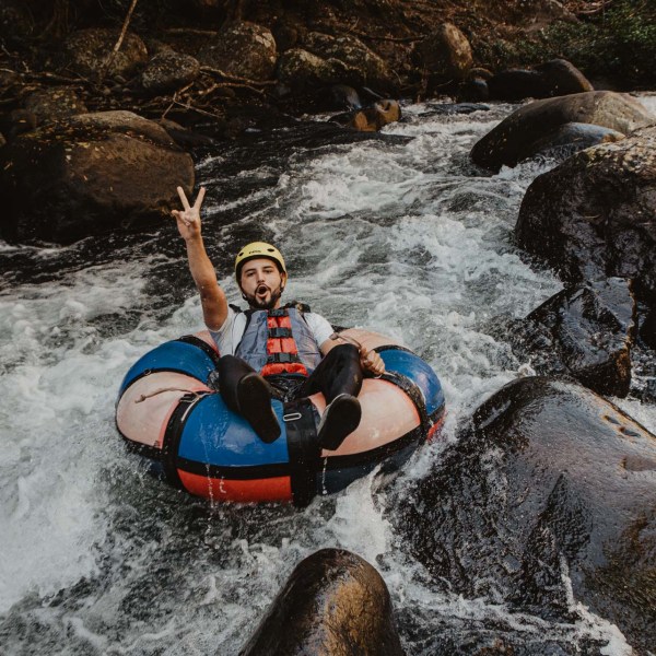 a man lying on a raft in a body of water