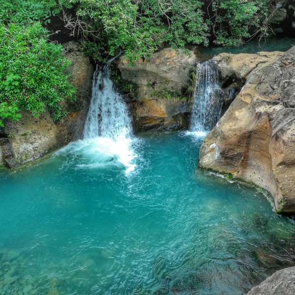 a large waterfall and a pool of water