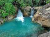 a large waterfall and a pool of water