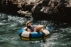a person sitting on a raft in a body of water