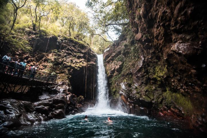 a large waterfall over some water