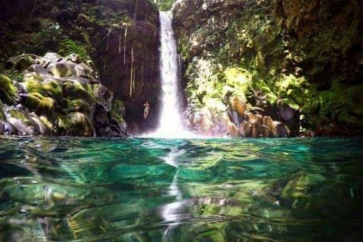 a large waterfall over some water
