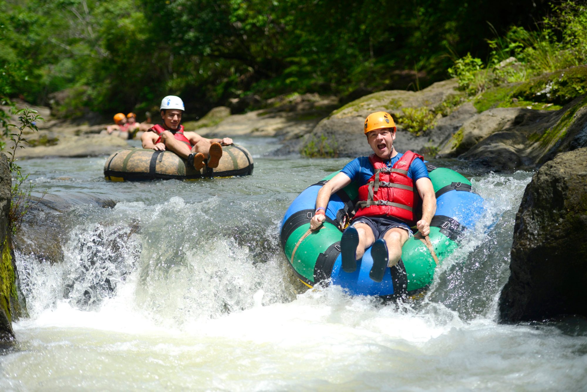 a group of people riding on a raft in a body of water