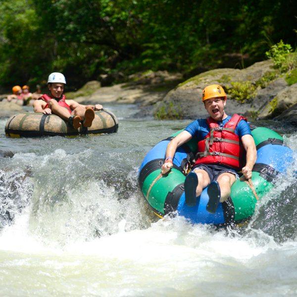 a group of people riding on a raft in a body of water