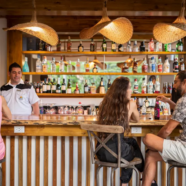 a person sitting on a bench in front of a fence