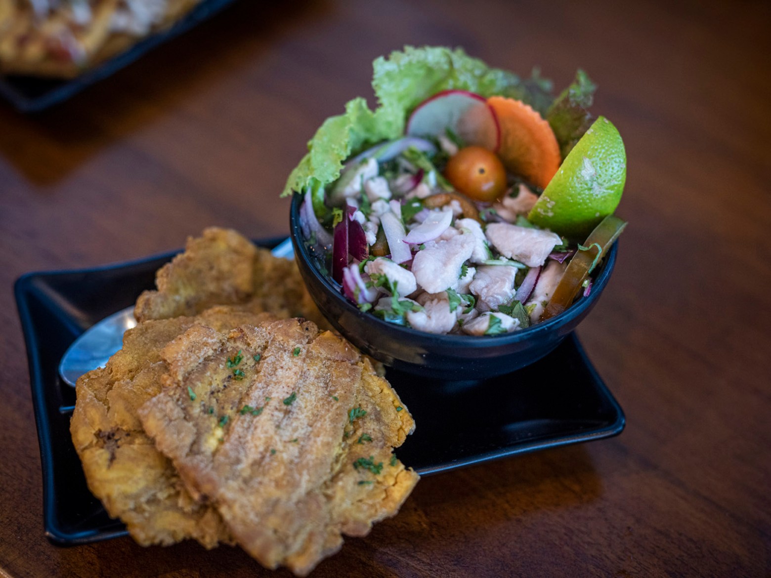 a plate of food with a slice of cake on a table