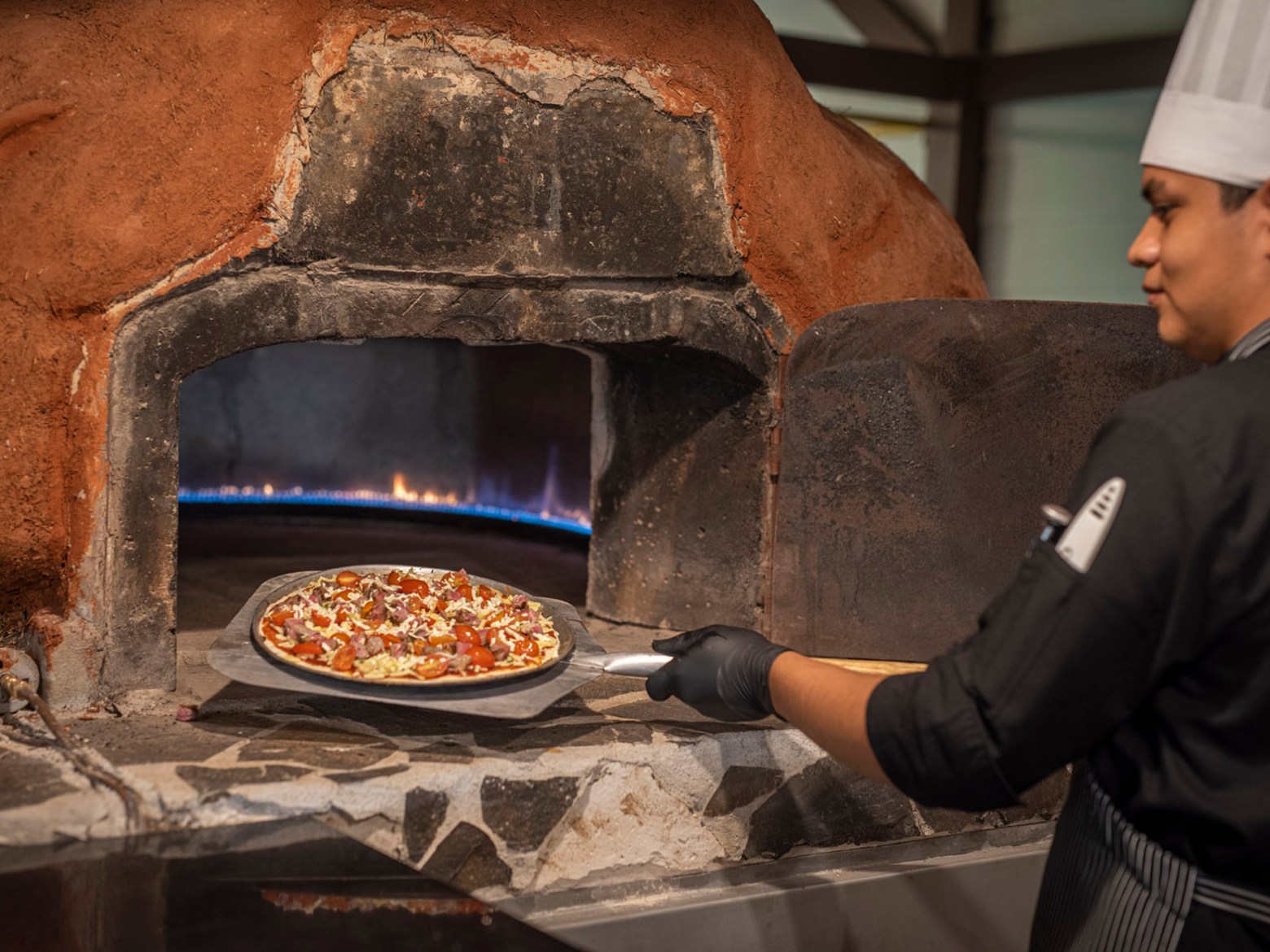 a man cooking pizza