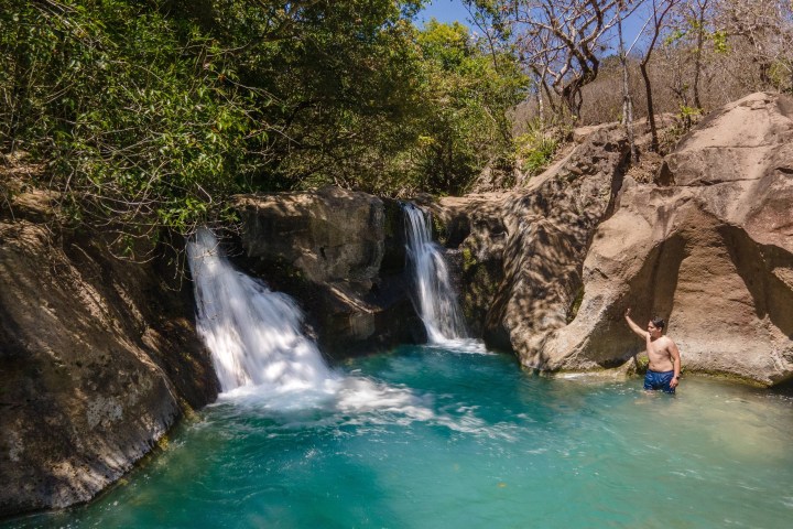 a large waterfall over some water