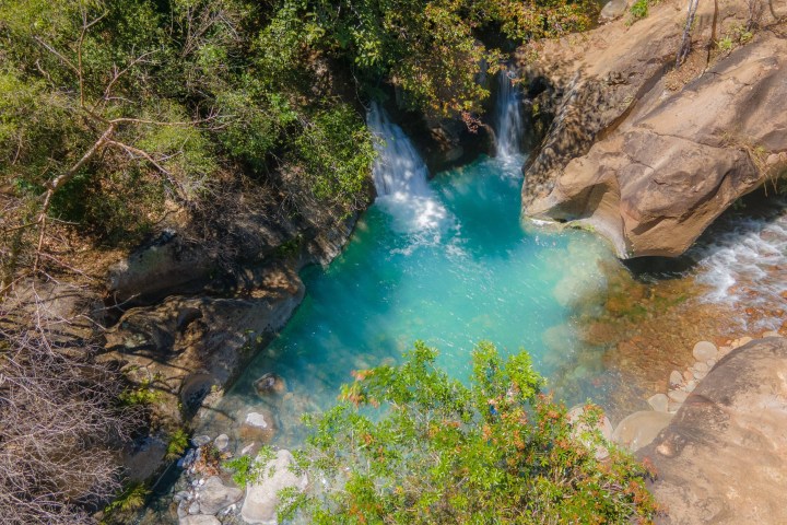 a large waterfall and a pool of water