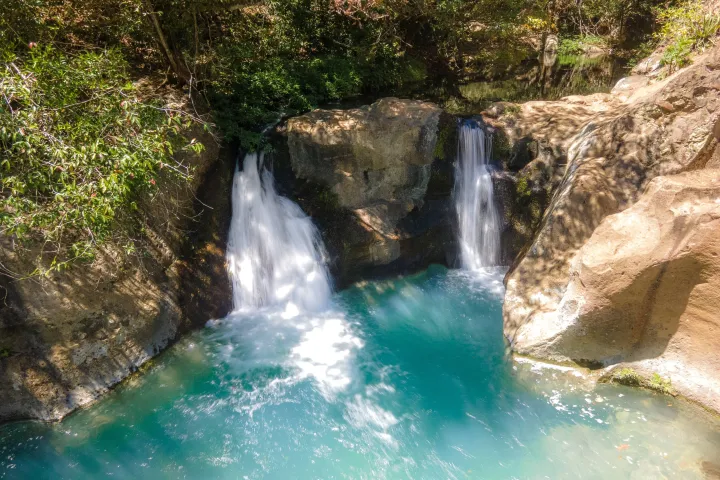 a large waterfall and a pool of water