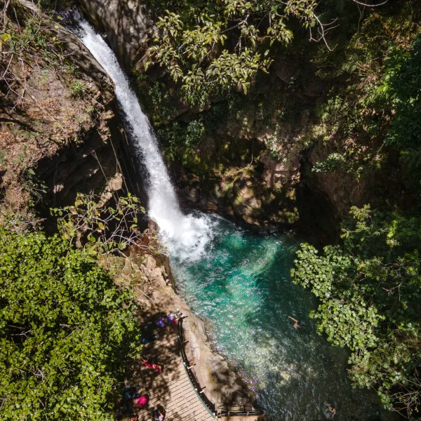 a waterfall with trees in the background