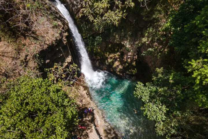 a waterfall with trees in the background