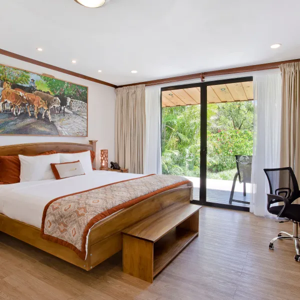 a bedroom with a bed and a chair in a room