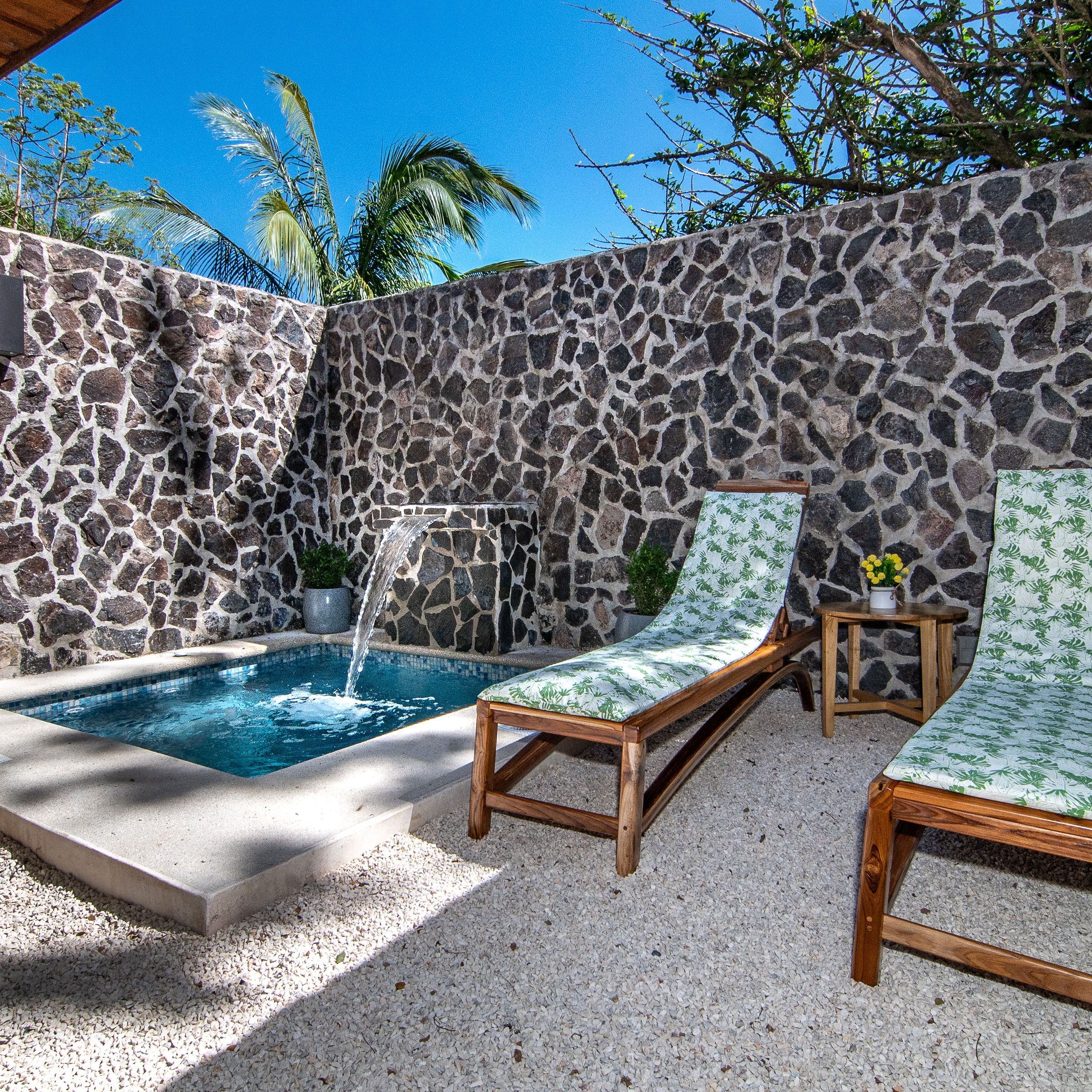 a chair sitting next to a stone wall