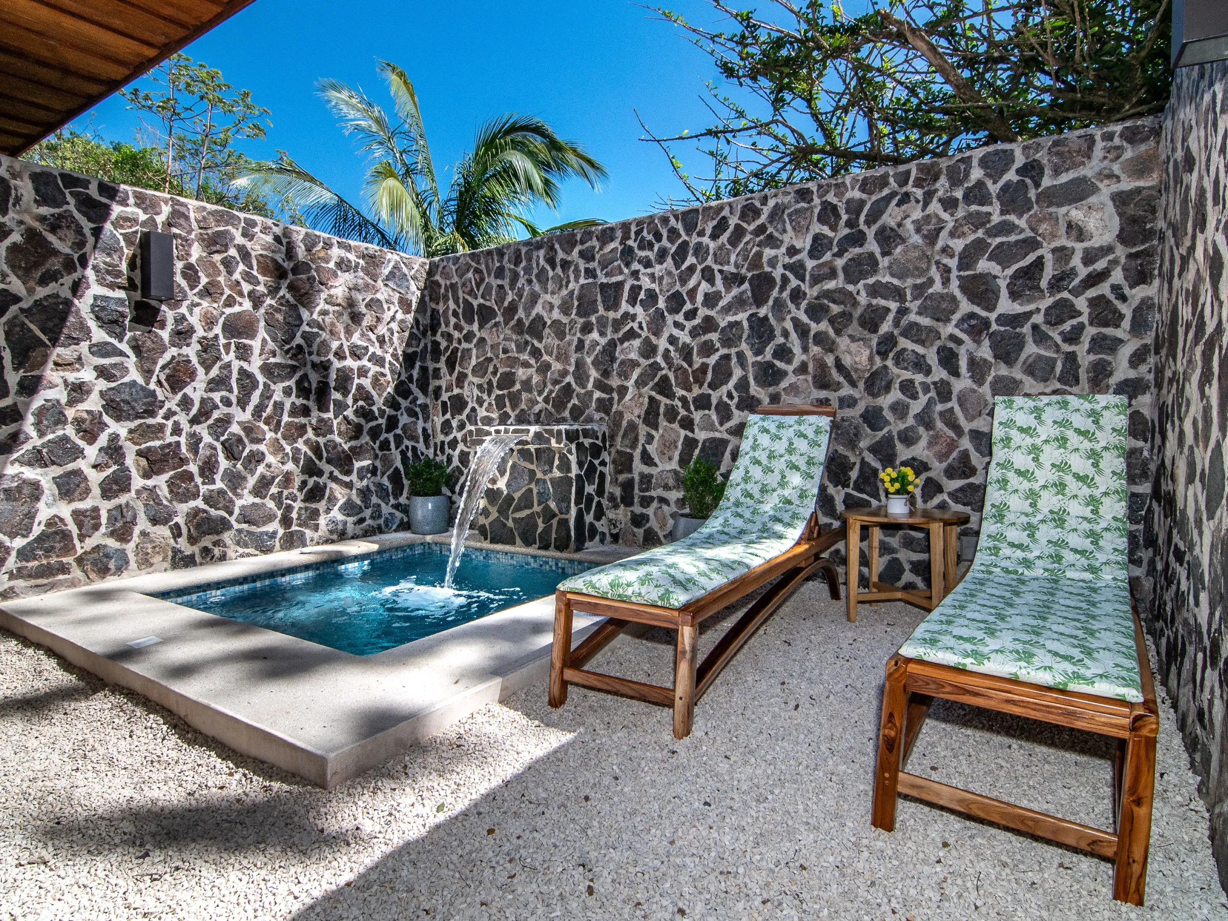 a chair sitting next to a stone wall