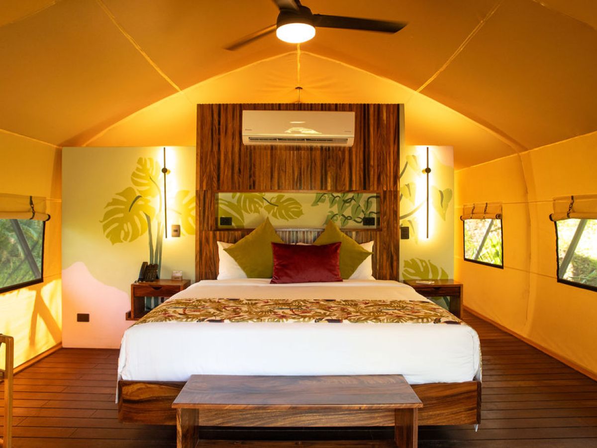 a bedroom with a bed and desk in a room