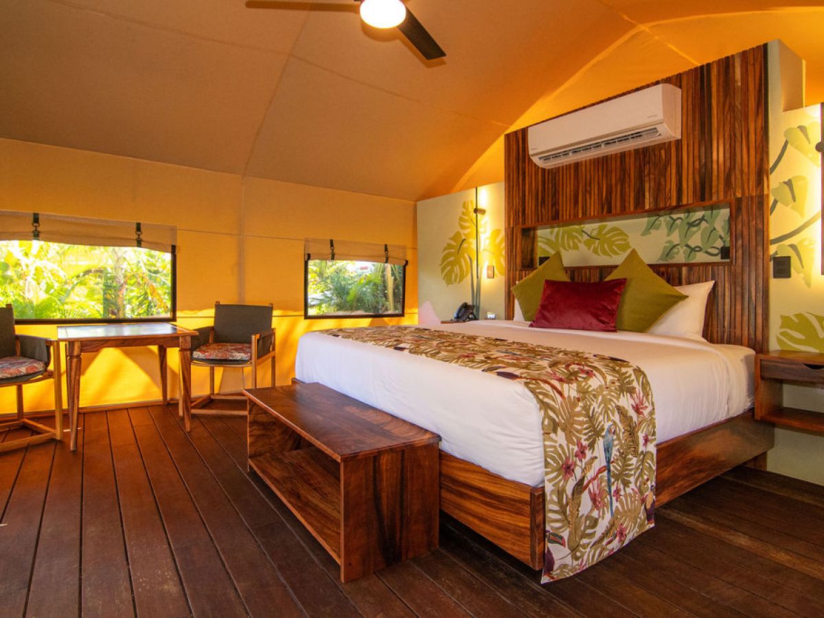 a bedroom with a bed and desk in a room