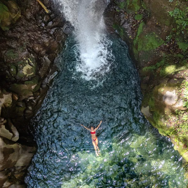 a person standing next to a waterfall