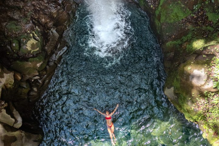 a person standing next to a waterfall