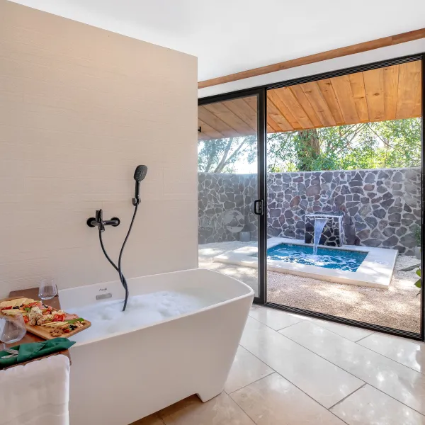 a glass of beer on a table next to a window
